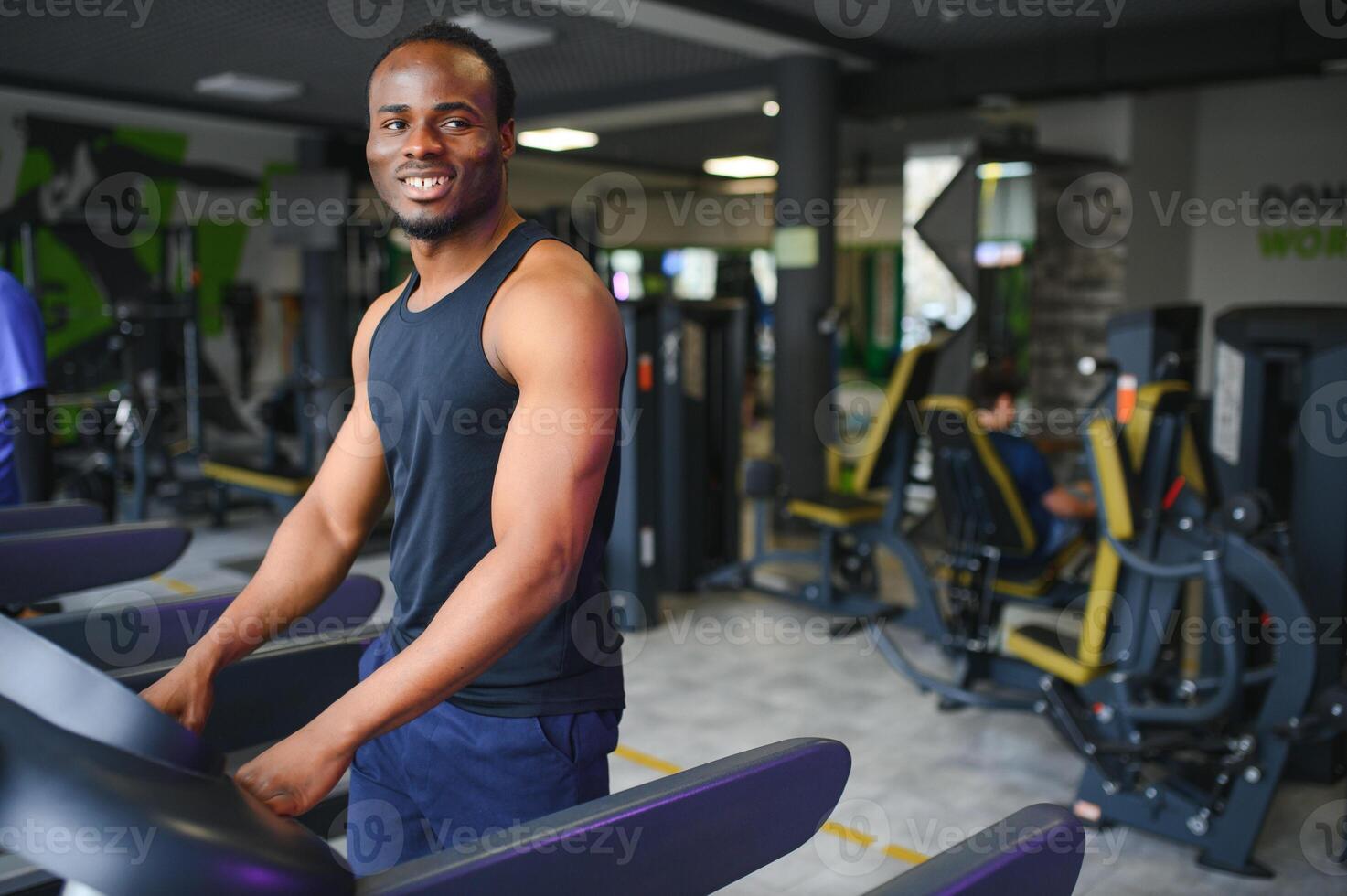 Man running on treadmill in gym photo