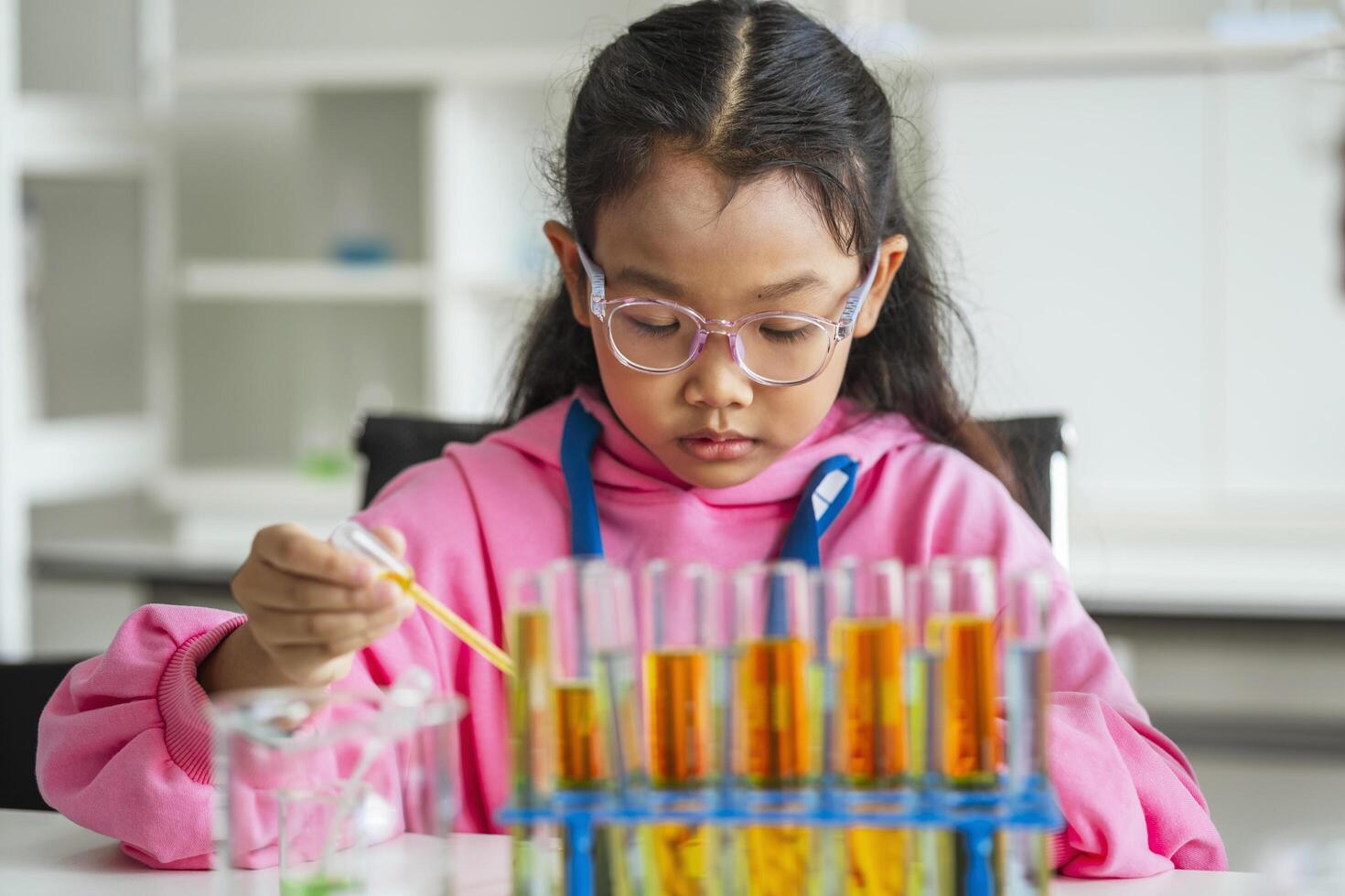 School children are doing chemistry experiments for classroom learning photo