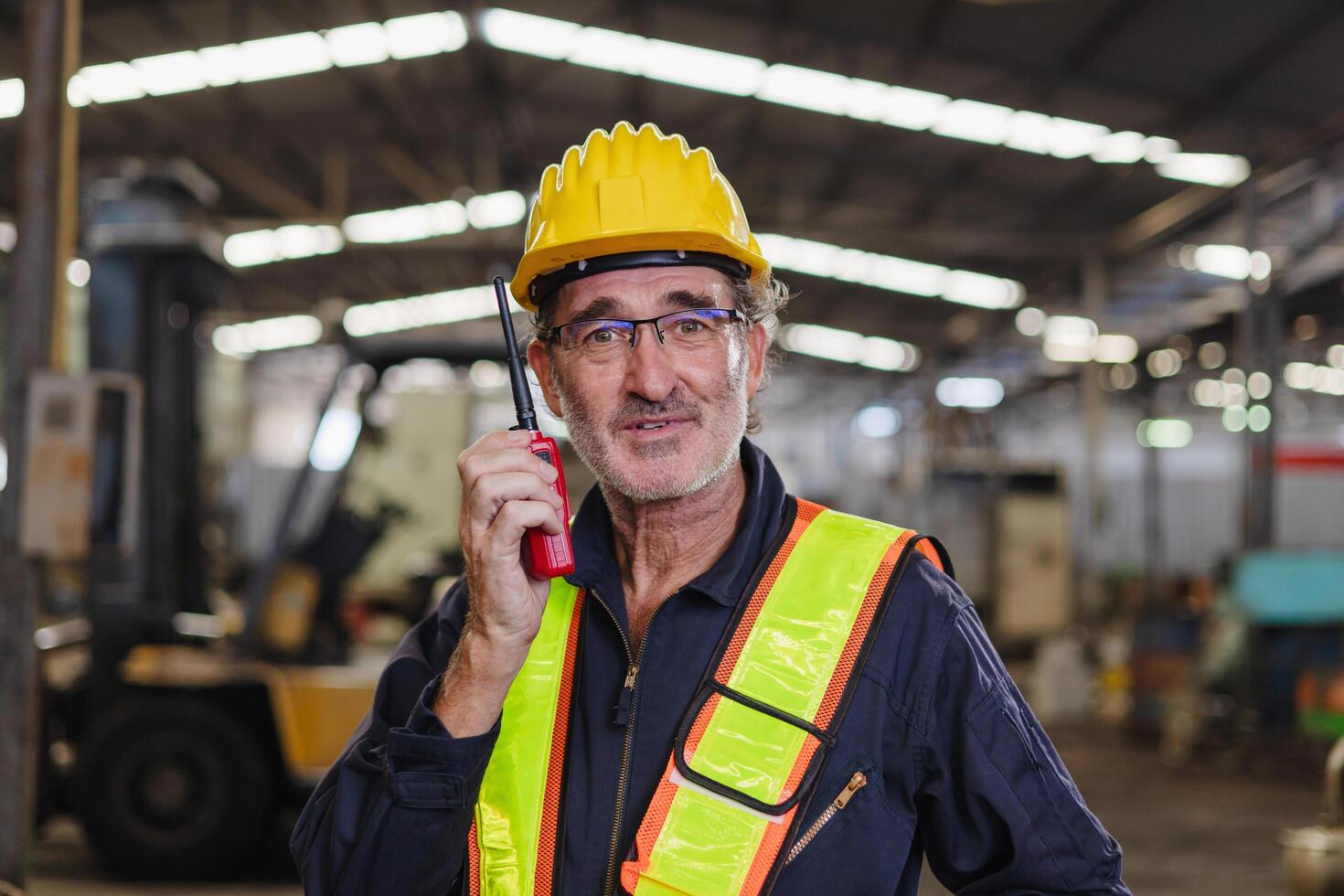 engineer use walkie talkie at machine factory photo