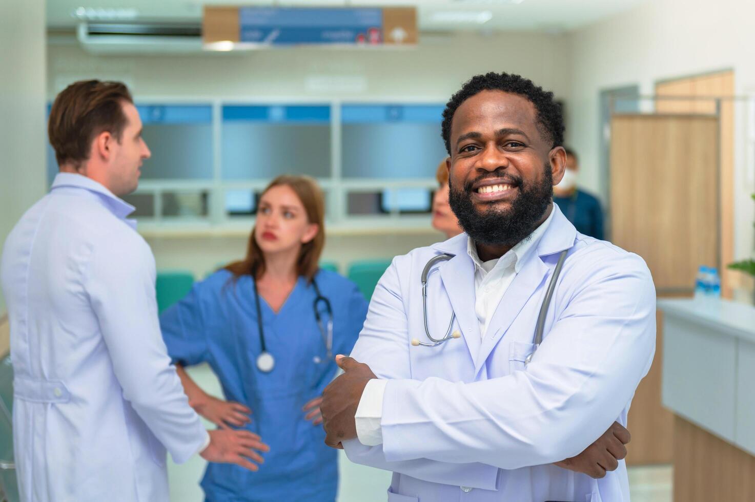 doctor crossed his arms in confidence and there were doctors and nurses behind him photo