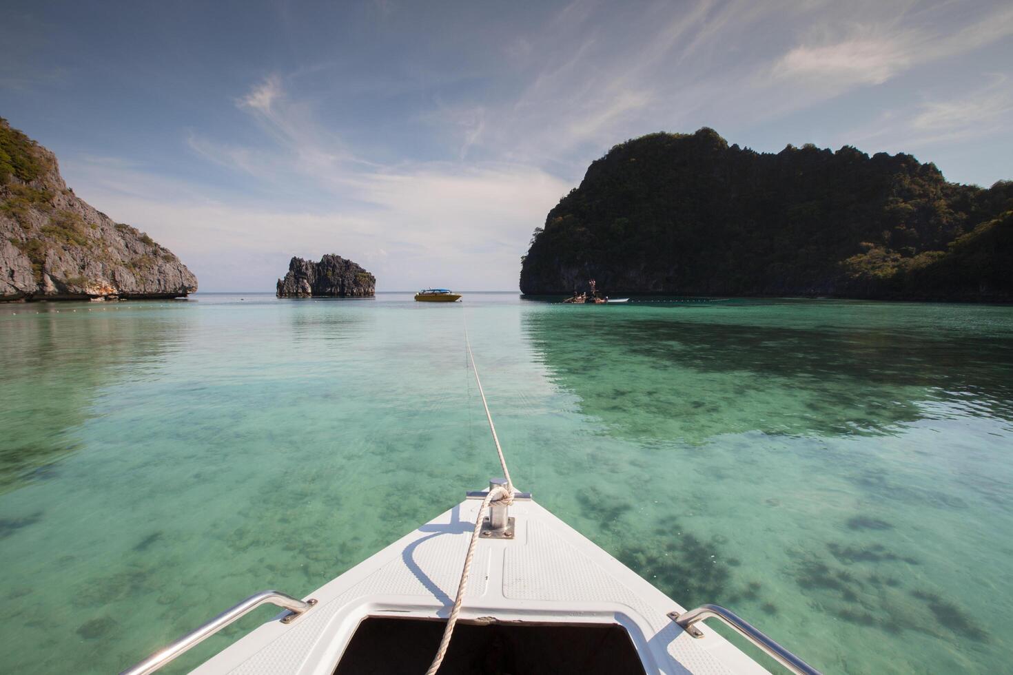 long tail boat view in front of sea photo