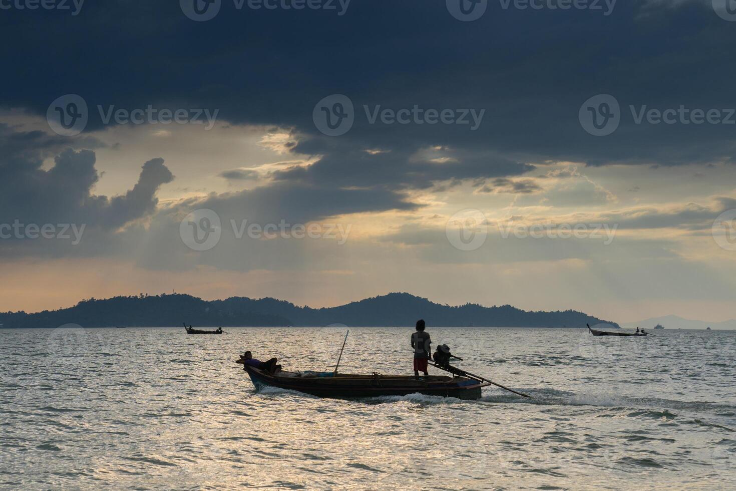 fisherman on longboat reflection on water photo