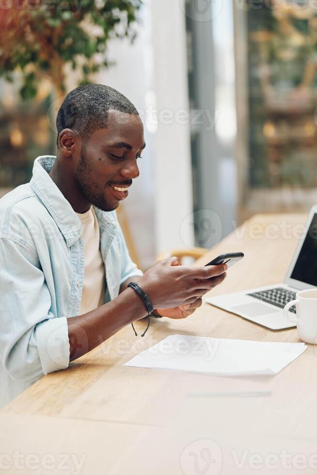 Man sitting working phone internet computer communication business young professional smiling photo