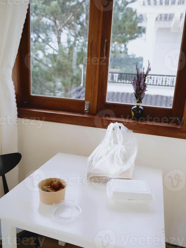Food from delivery on the table in plastic utensils, a fast food concept photo