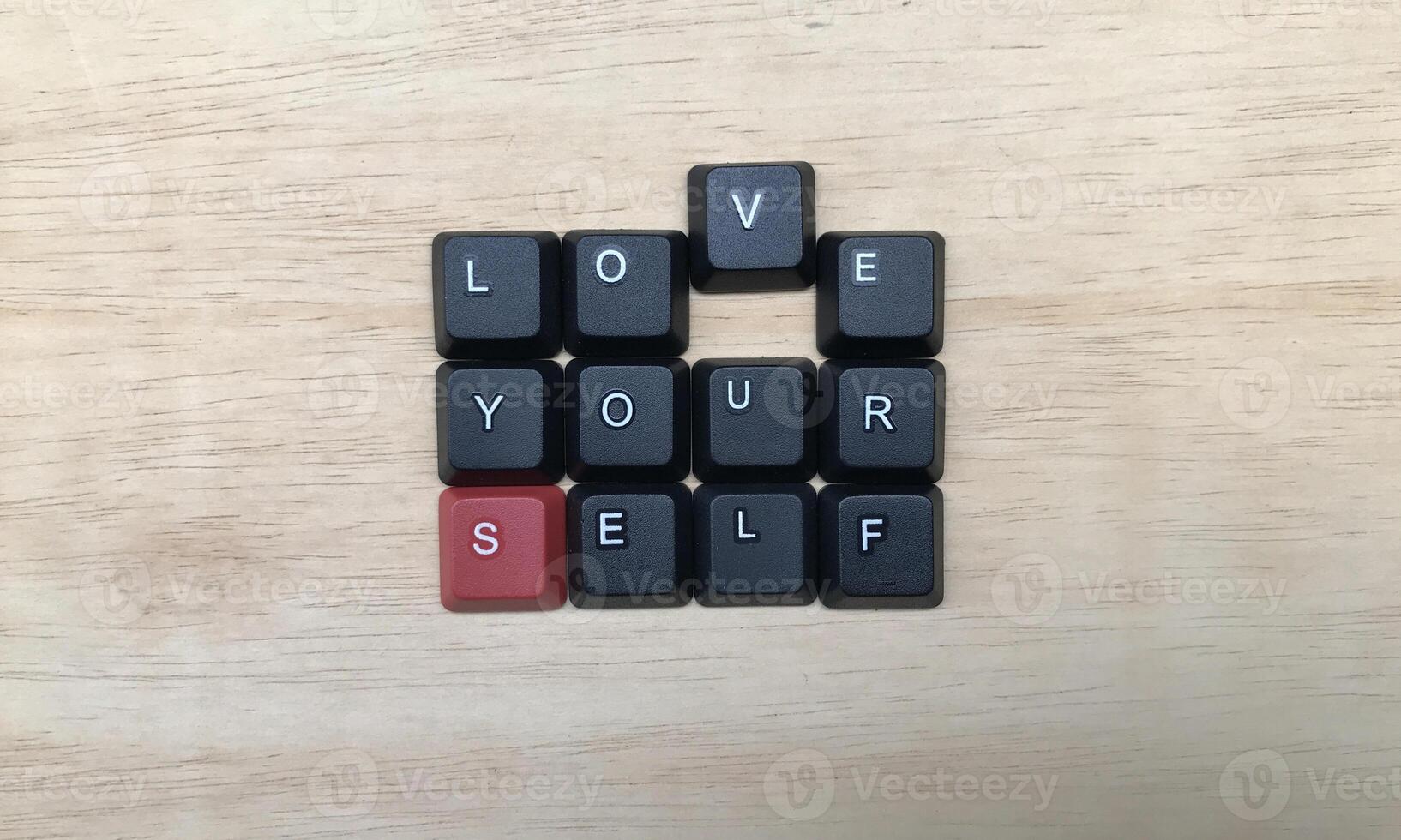 Love yourself word on black keyboard button on wood background, Love yourself concept photo