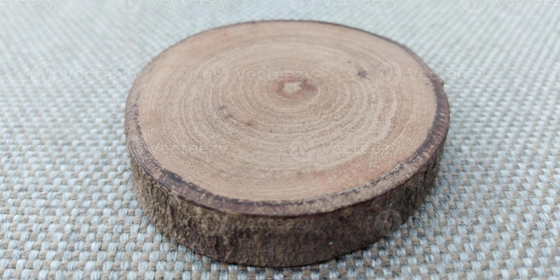 Cross section of tree trunk showing growth rings on a textured background photo