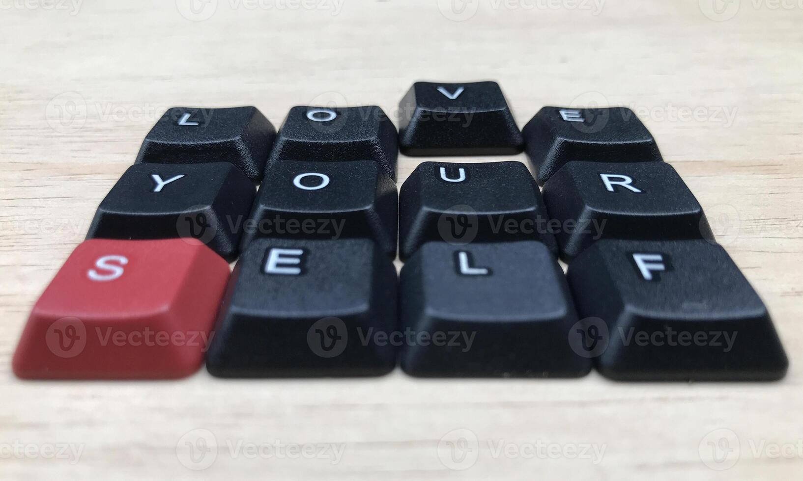 Love yourself word on black keyboard button on wood background, Love yourself concept photo