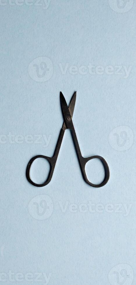 Hair cutting shears on a blue background. Top view. photo