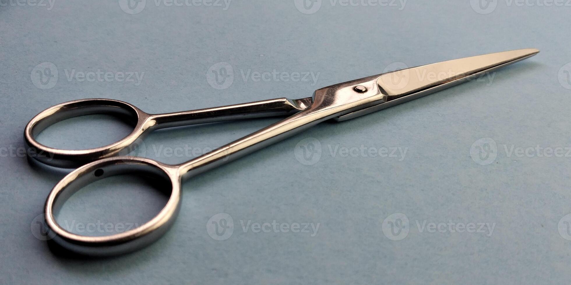 Hair cutting scissors on blue background. Hairdresser tools. photo