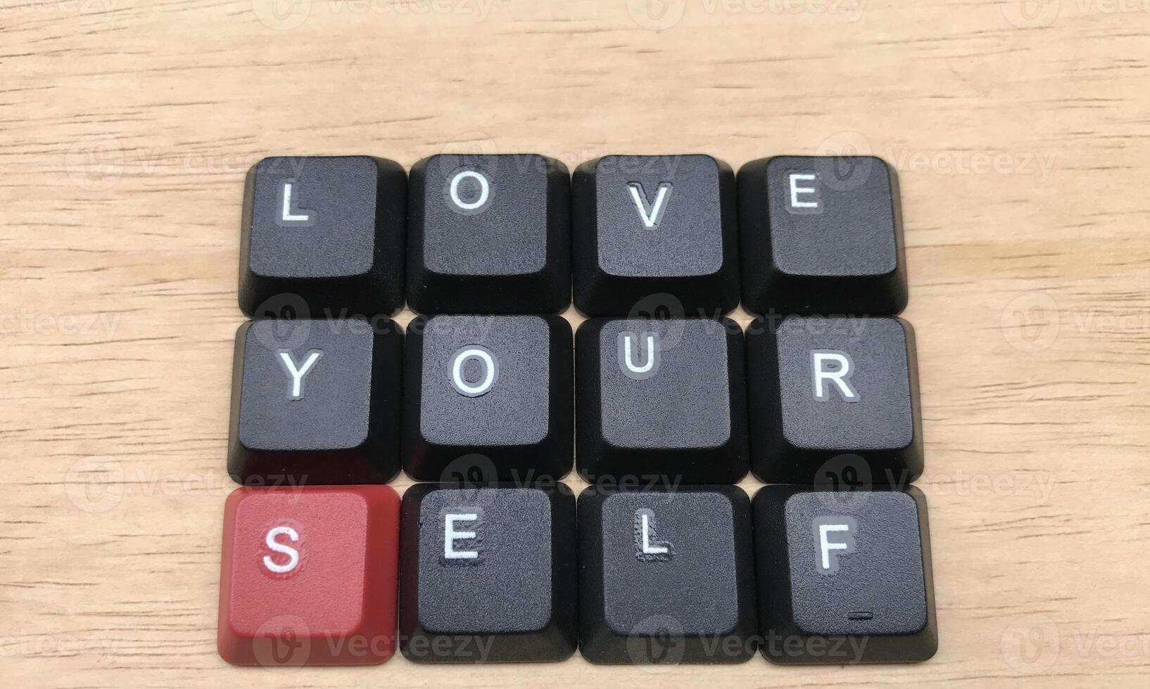 Love yourself word on black keyboard button on wood background, Love yourself concept photo