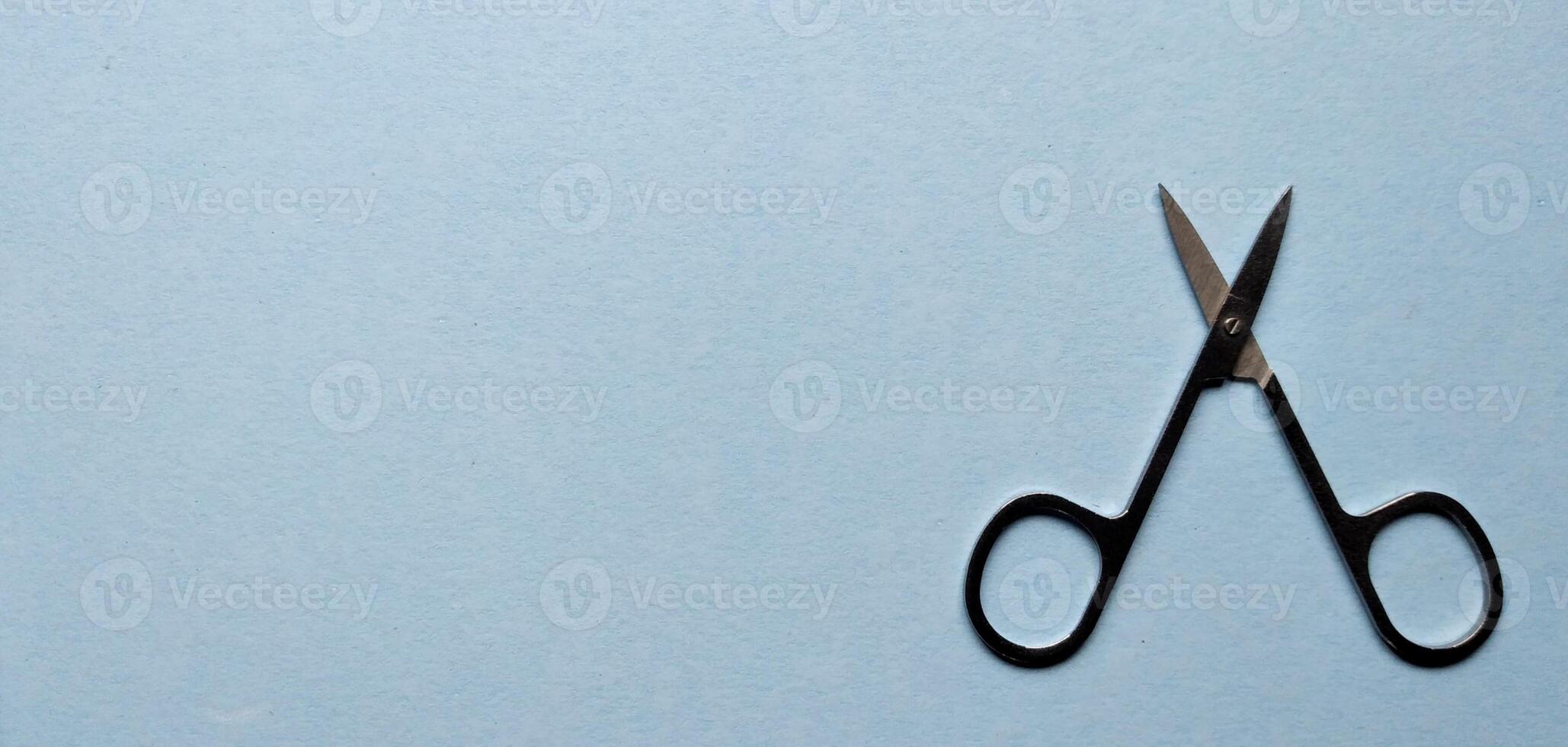 Hair cutting shears on a blue background. Top view. photo