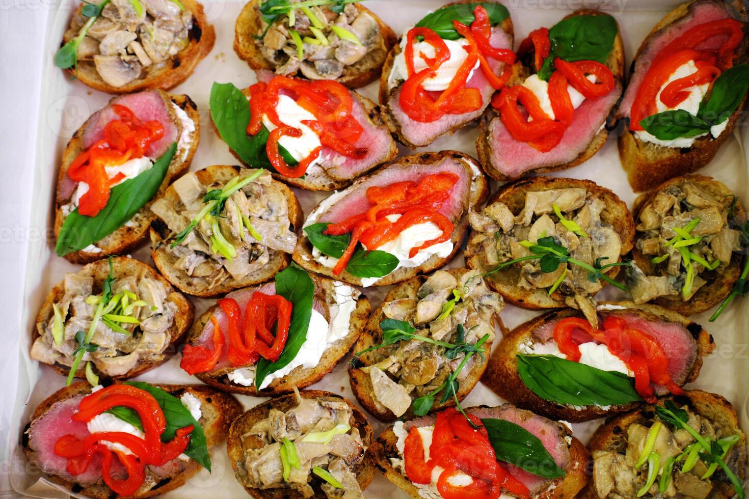 Top View of Roast Beef Canapes and Mushroom Bruschetta in a Box photo