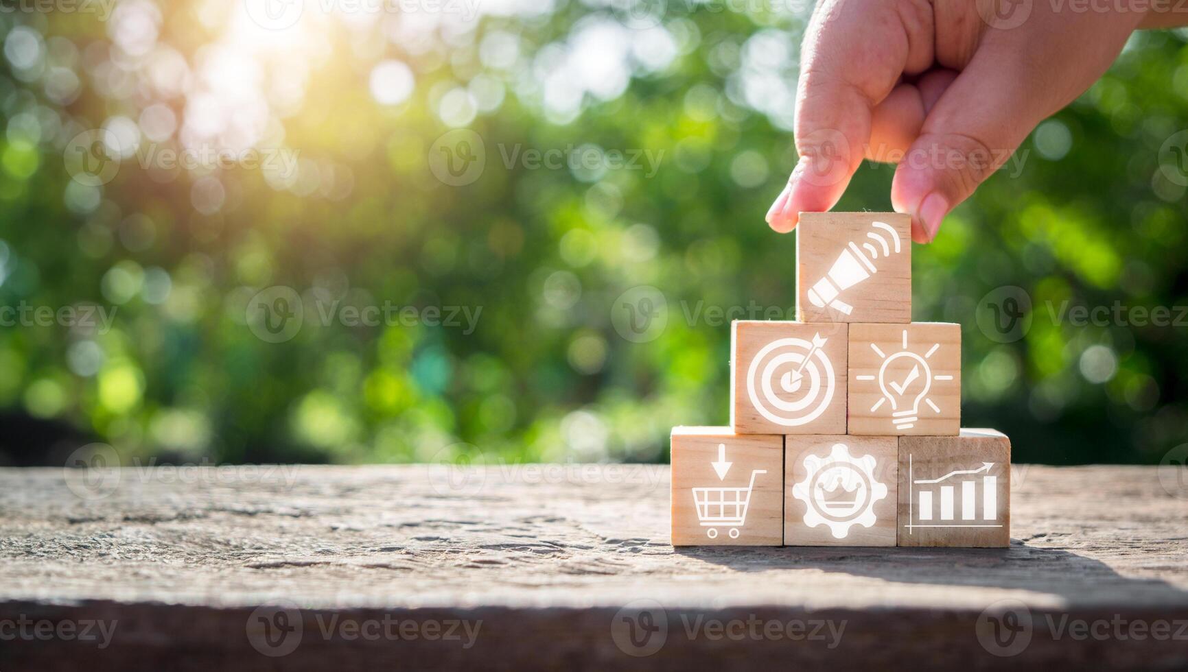 Advertising concept, Hand holding wooden block on desk with advertising icon on virtual screen. photo