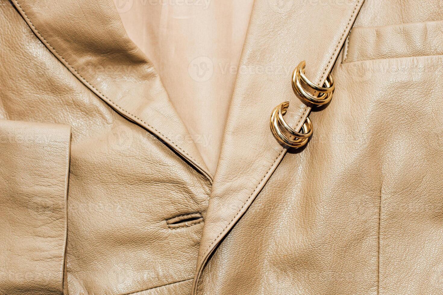 Decoration on the texture of a brown leather jacket, genuine soft leather. photo