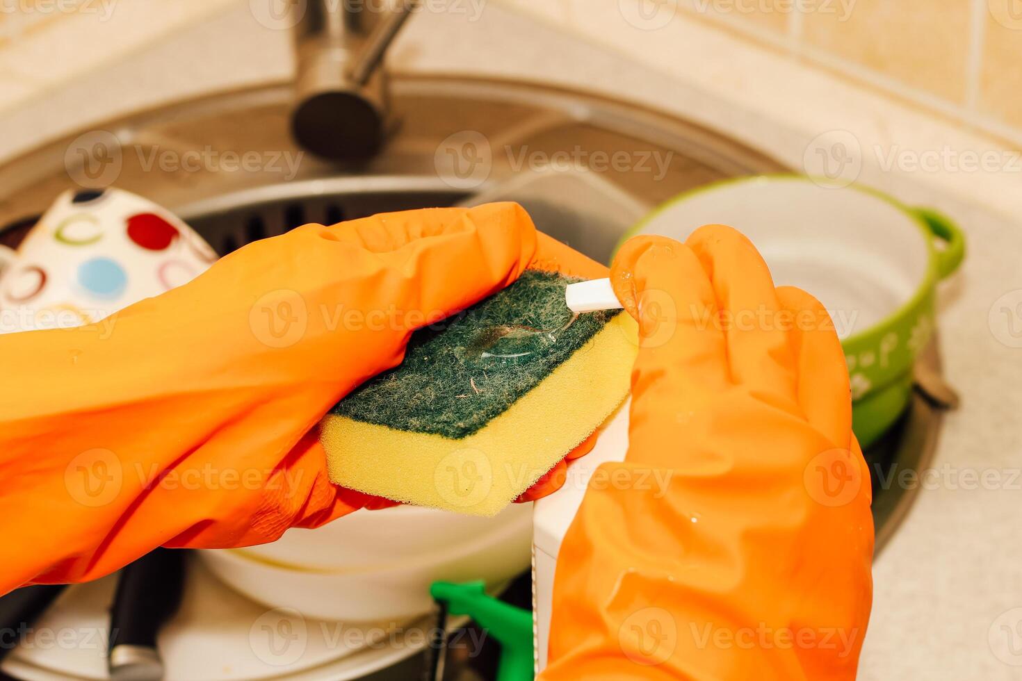 A pile of dirty dishes, cups, plates in the sink, washing with an eraser. photo