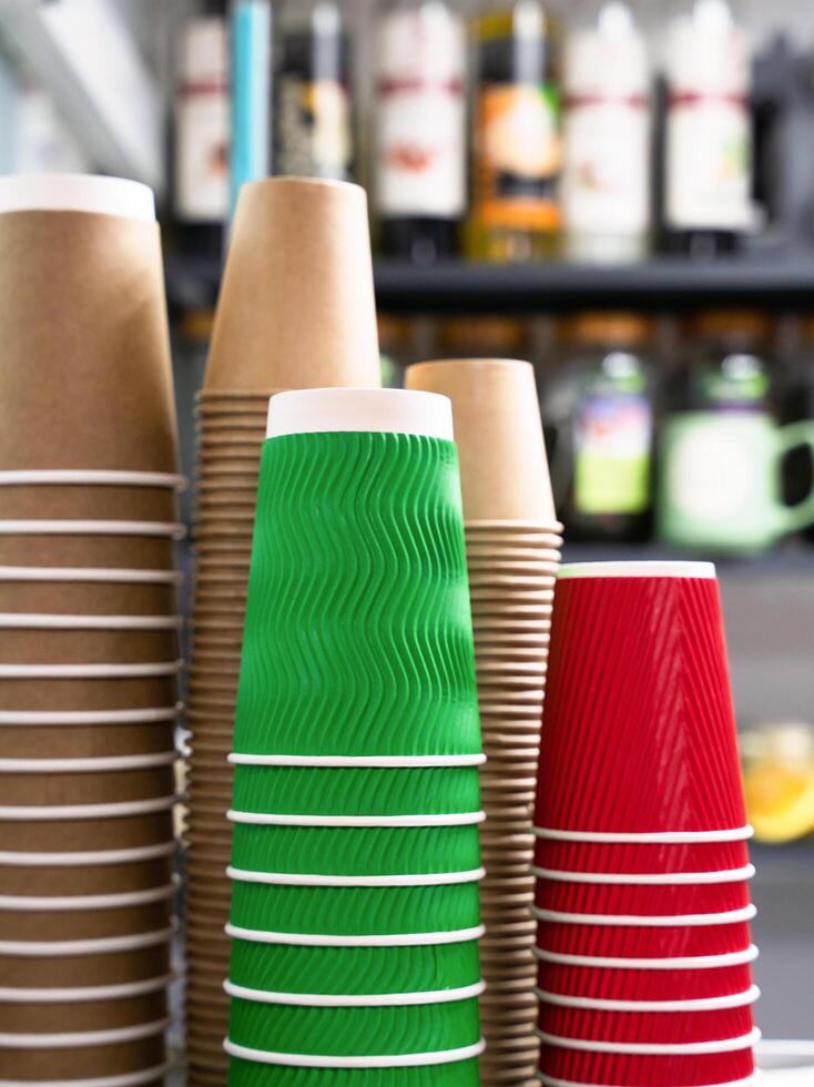 A stack of craft paper cups in a cafe. Coffee to go. Close-up. Selective focus. photo