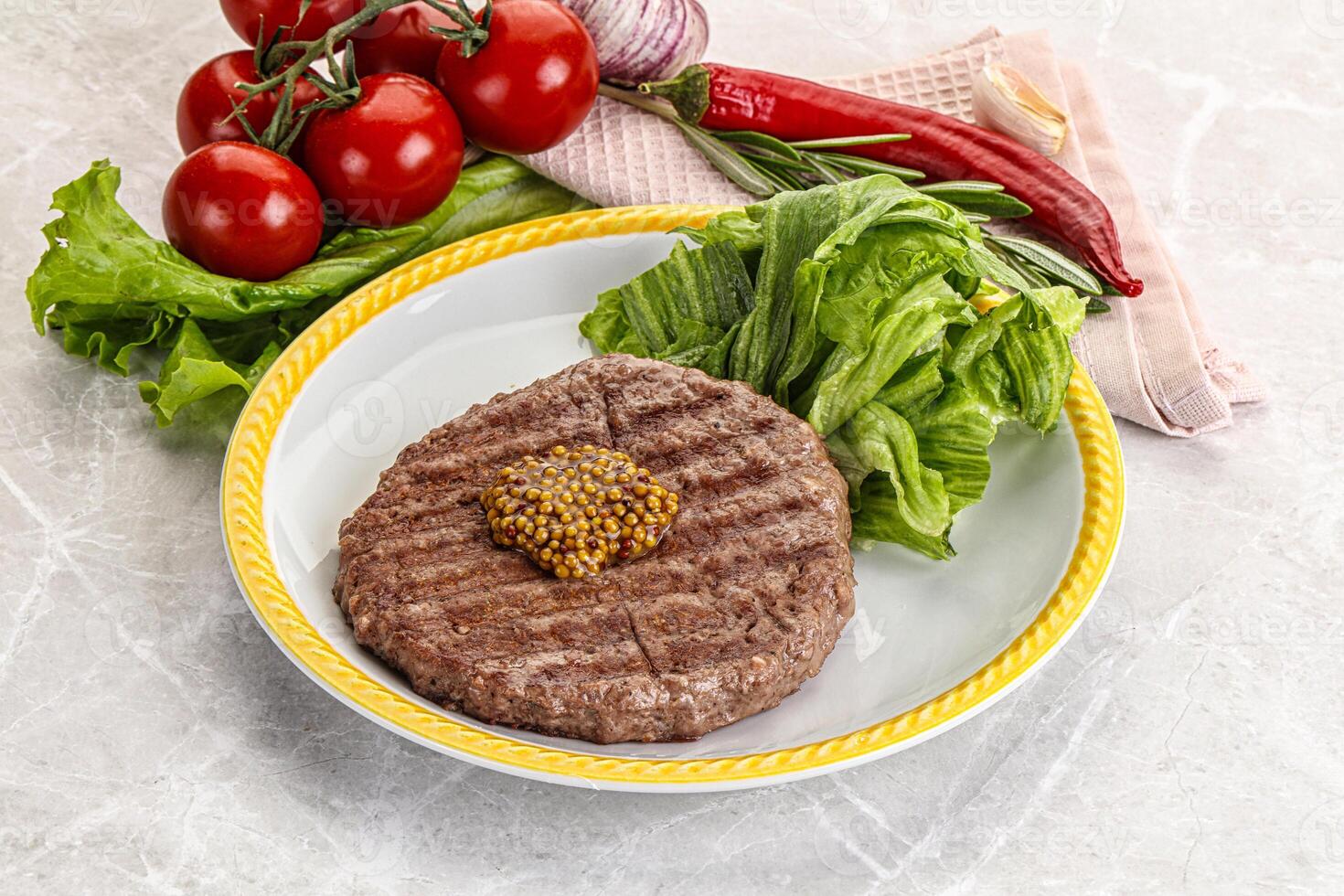 Frilled beef burger cutlet with iceberg photo
