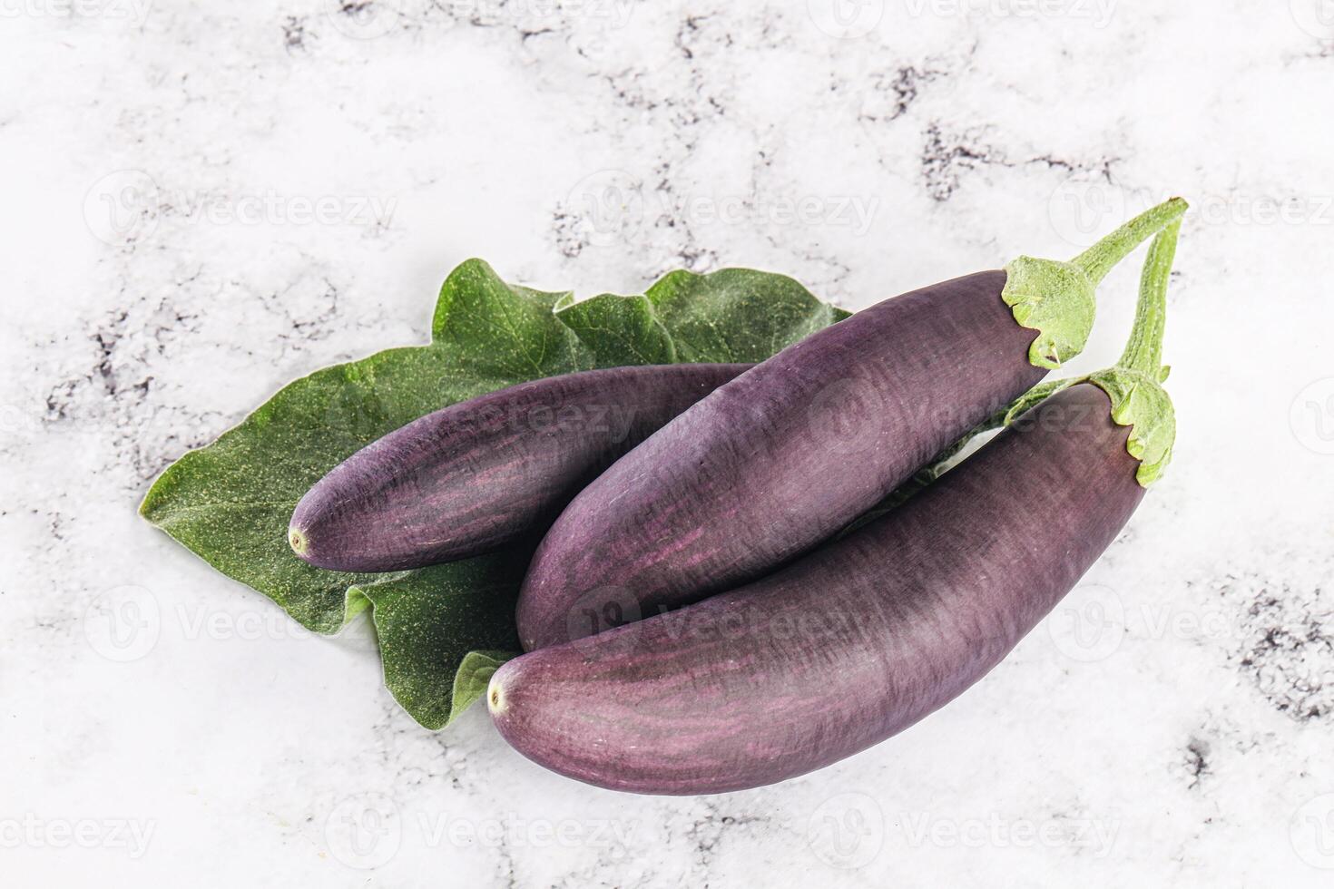 Raw ripe organic eggplant with leaf photo