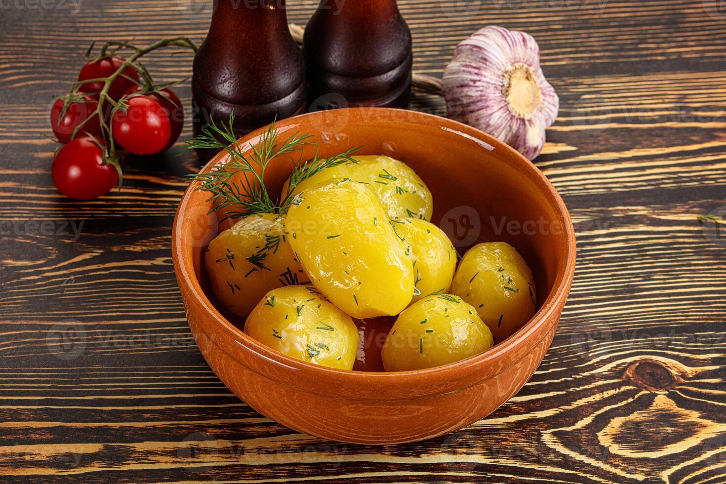 Boiled potato with oil and dill photo