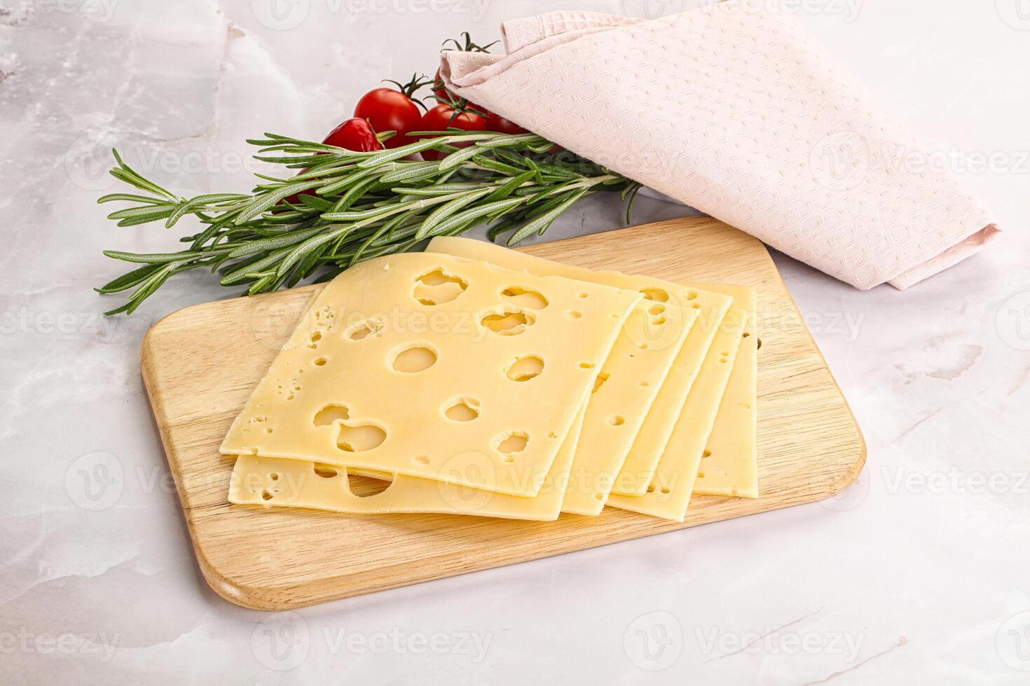 Sliced maasdam cheese with holes photo