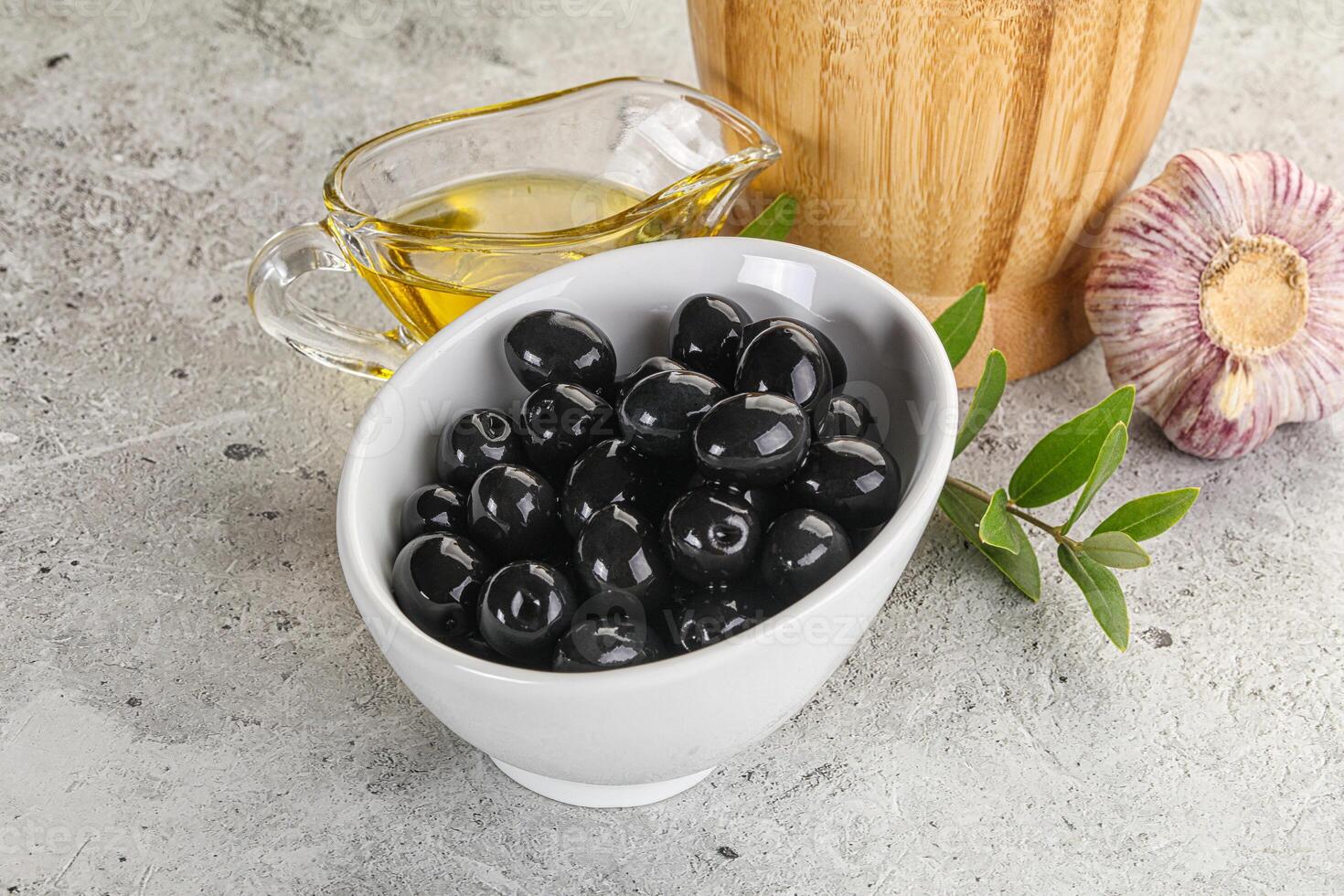 Black olives with oil and branch photo