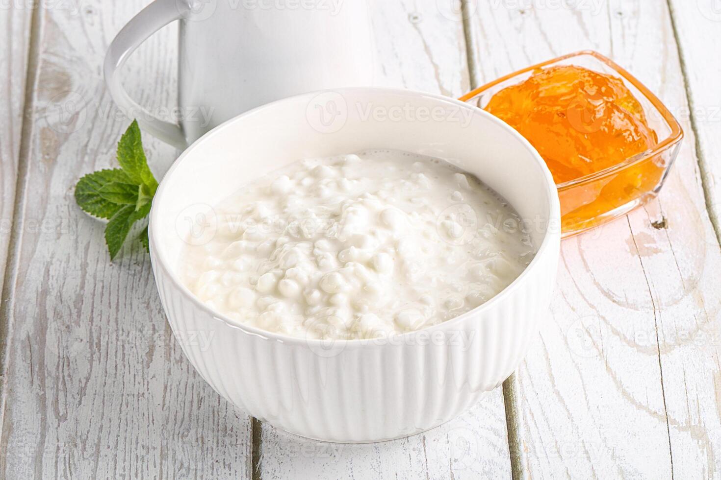 Grain curd with cream and jam photo