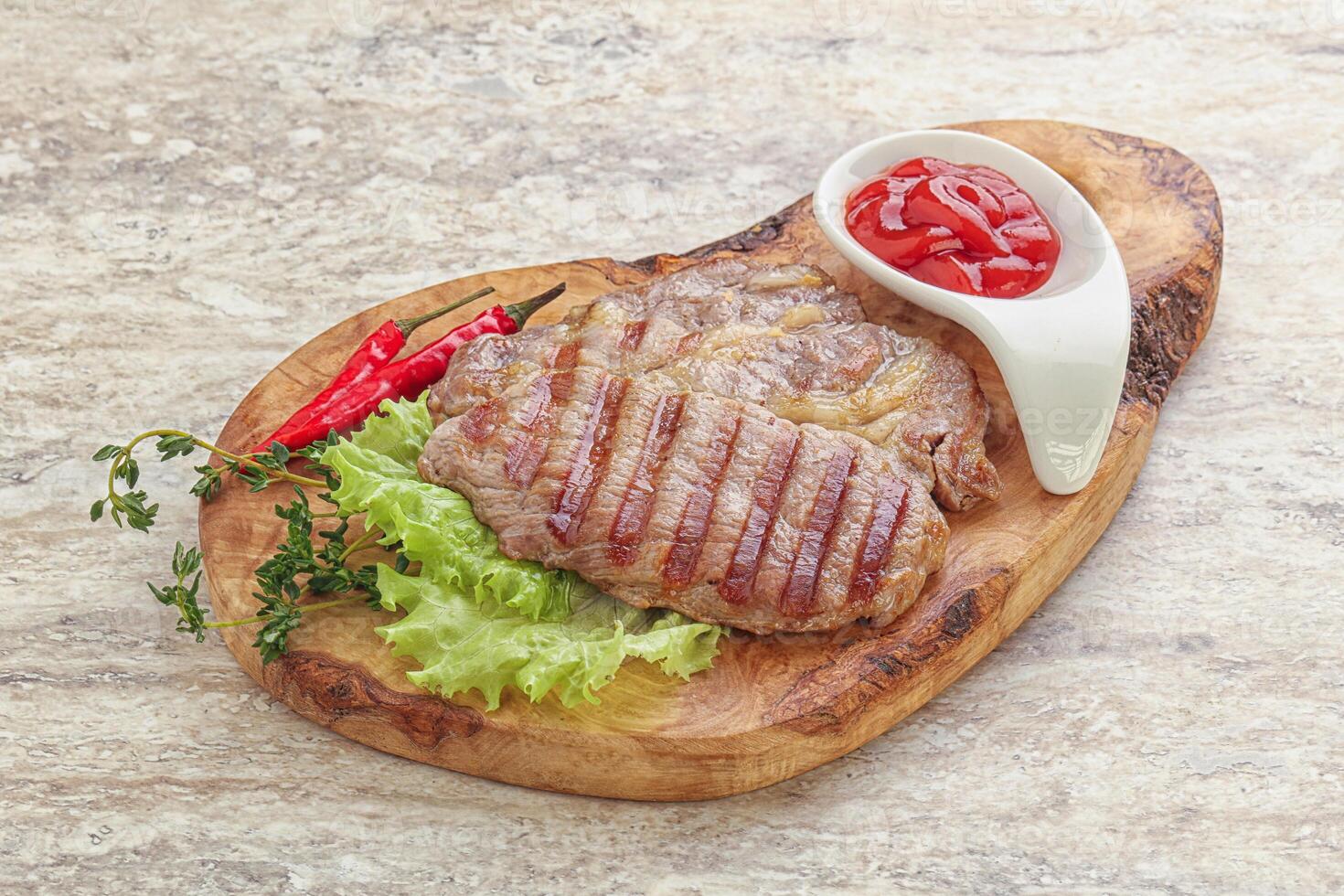 Grilled pork neck steak with ketchup photo