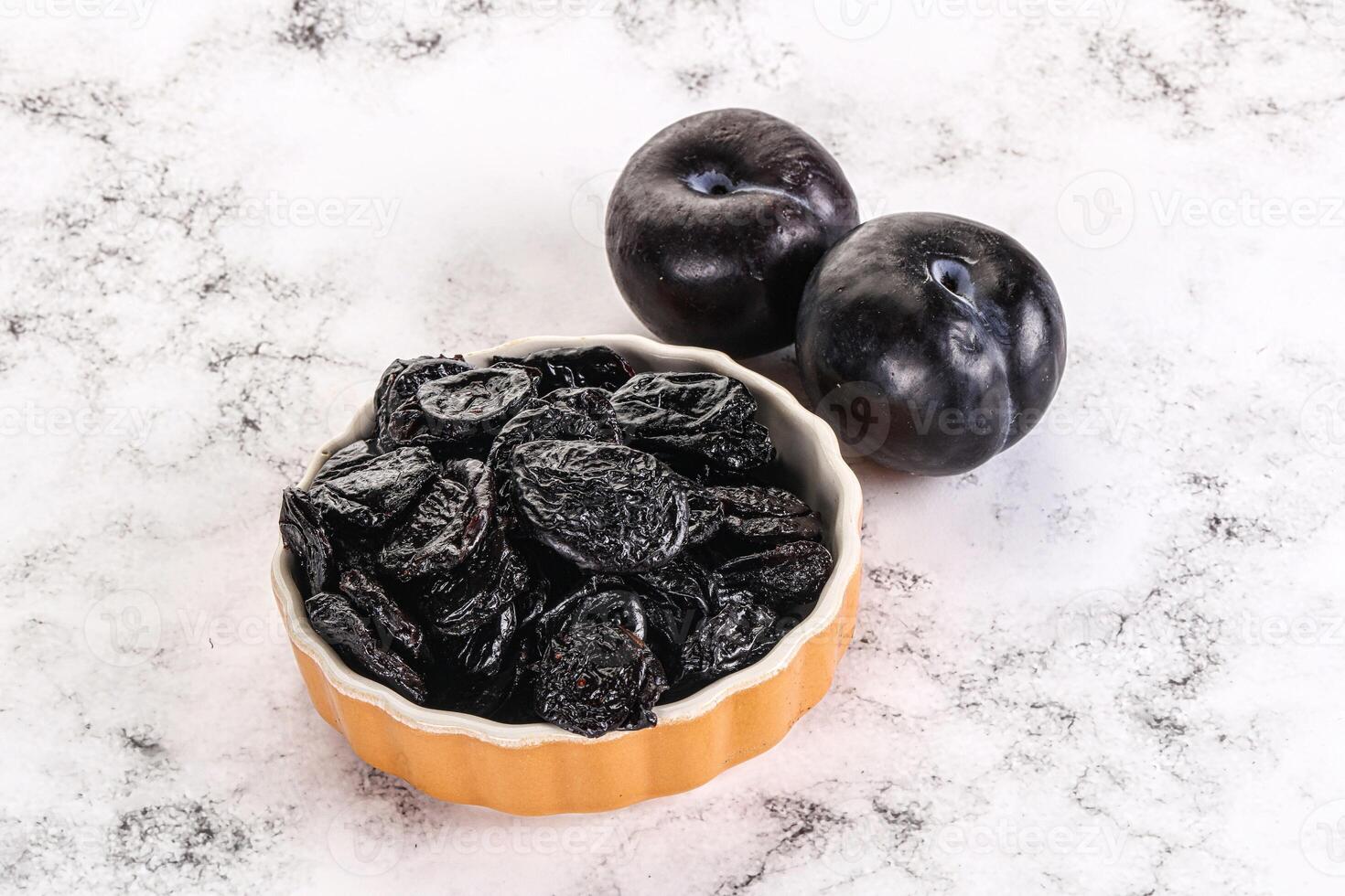 Dry prunes in thw bowl photo