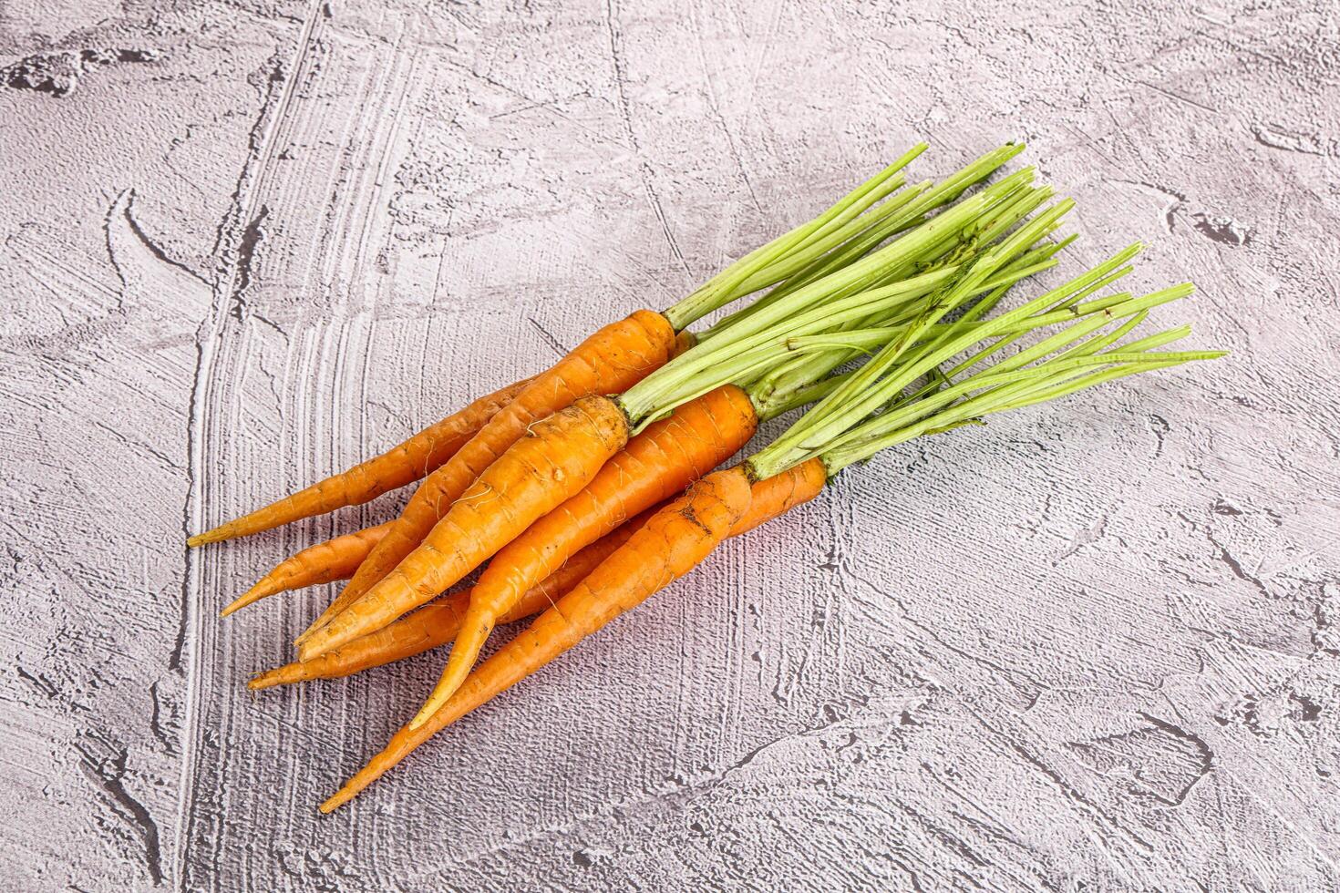 Young raw carrot heap isolated photo