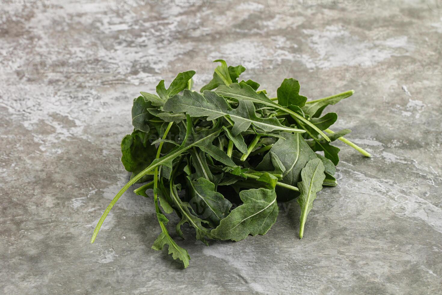 Green Arugula heap over background photo