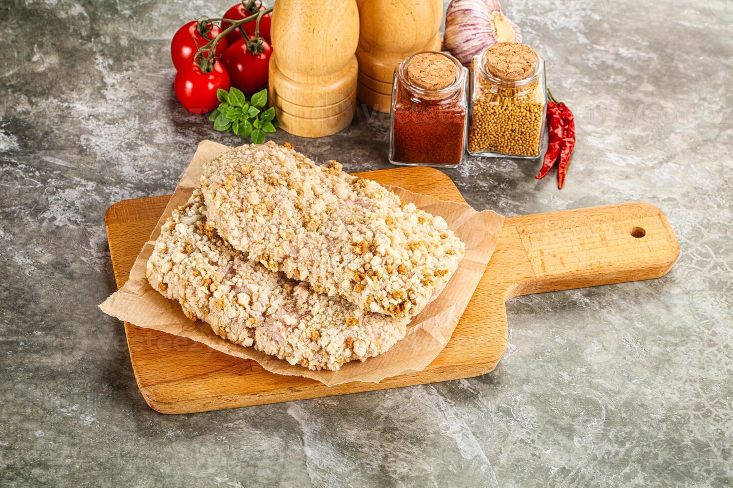 Breaded raw breaded meat schnitzel photo