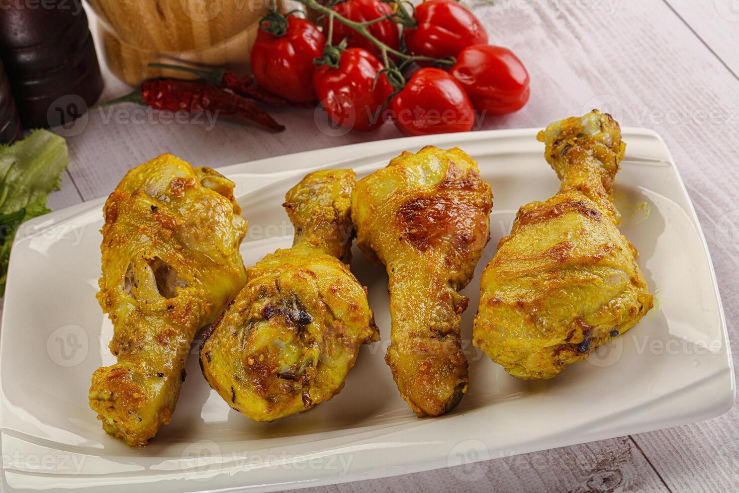 Roasted Chicken leg drumsticks with curry sauce photo