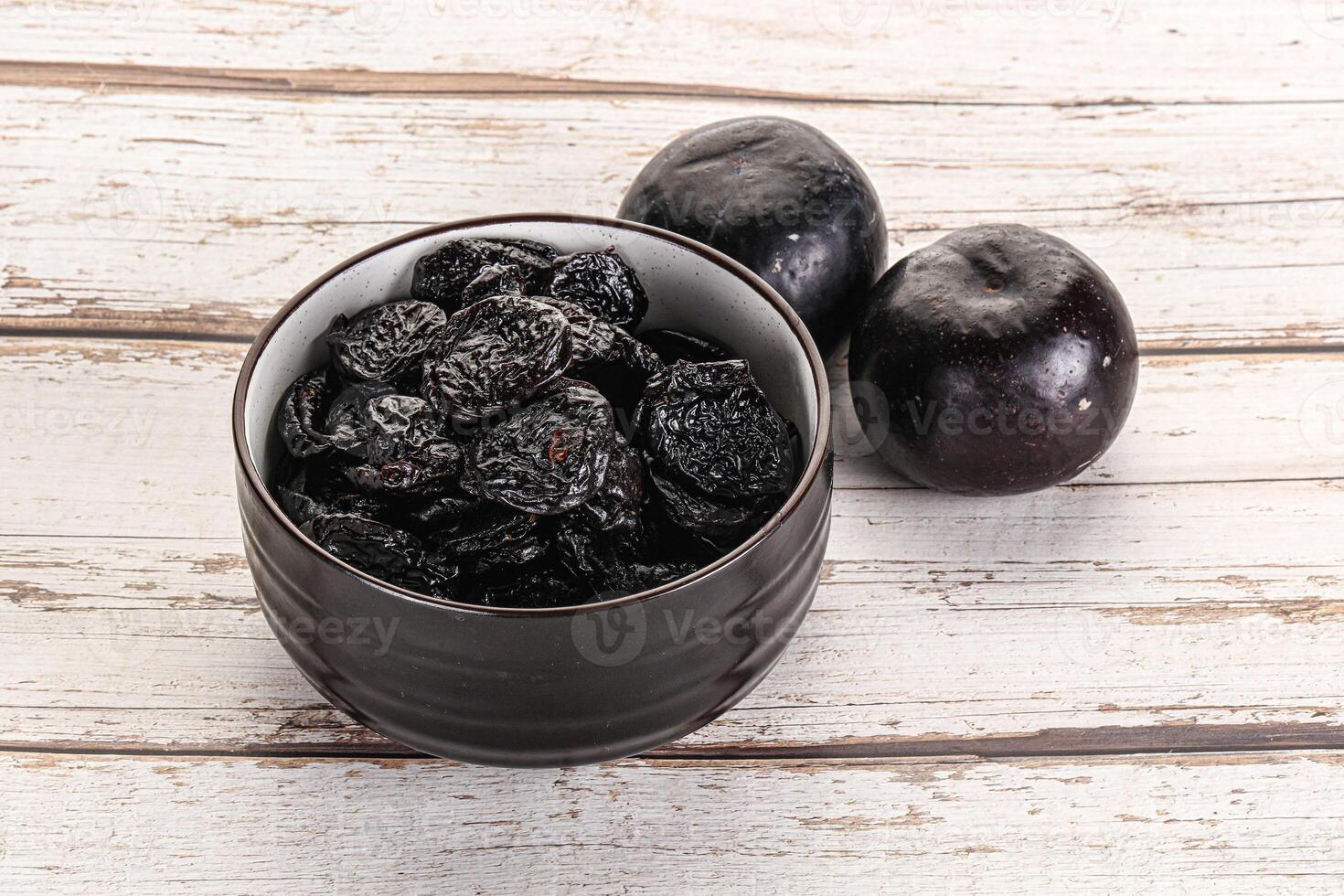 Dry prunes in thw bowl photo