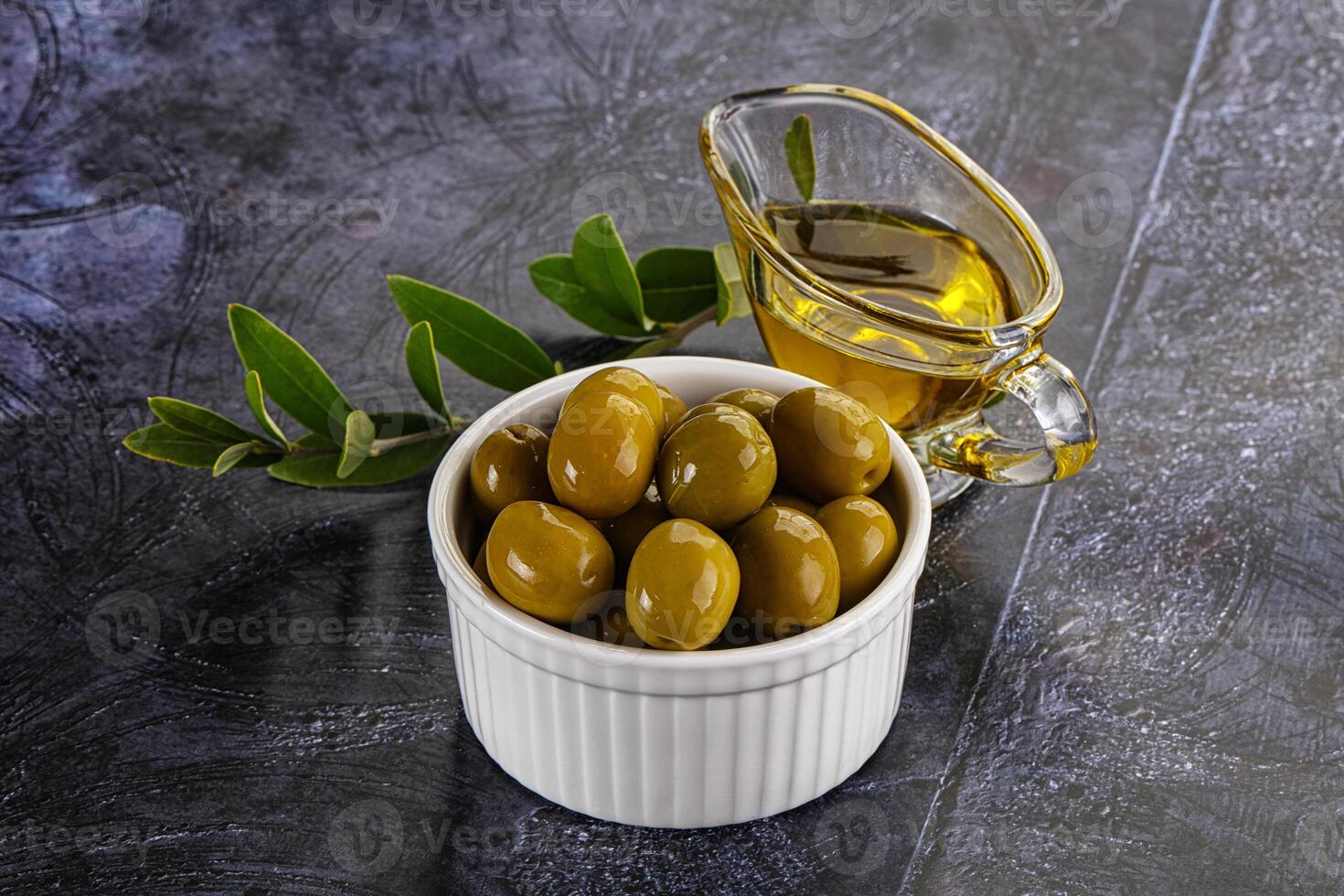 Ripe tasty green olives with branch photo
