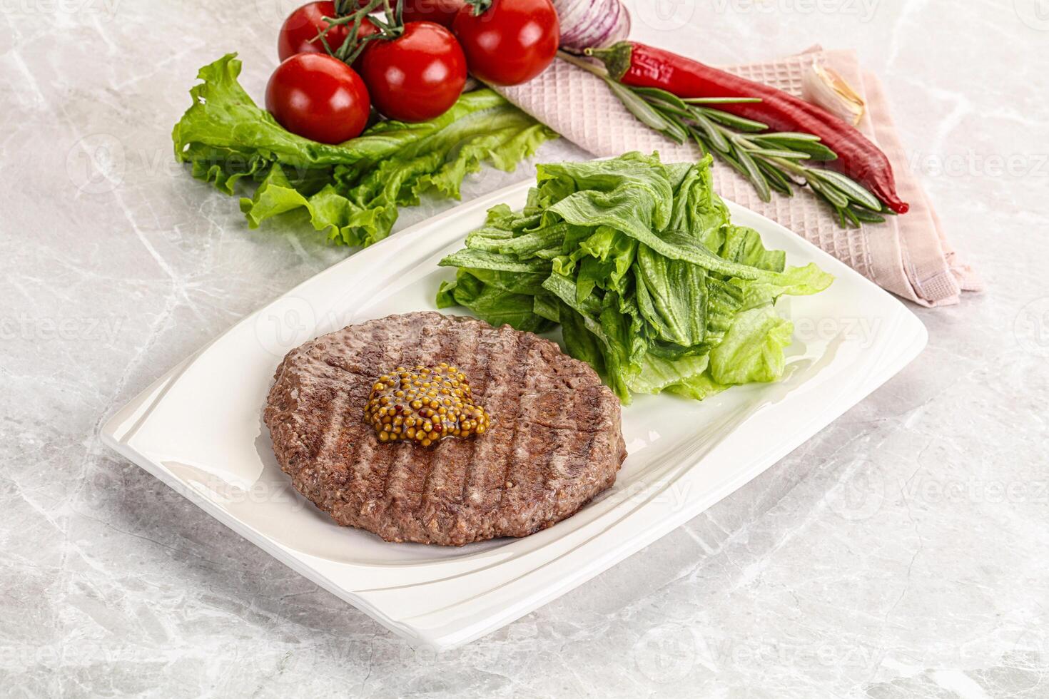 Frilled beef burger cutlet with iceberg photo