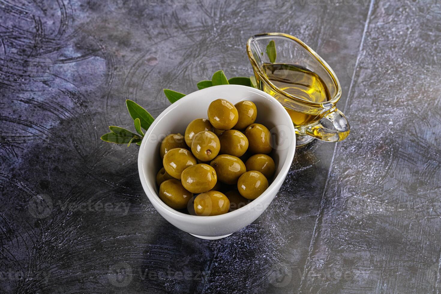 Ripe tasty green olives with branch photo