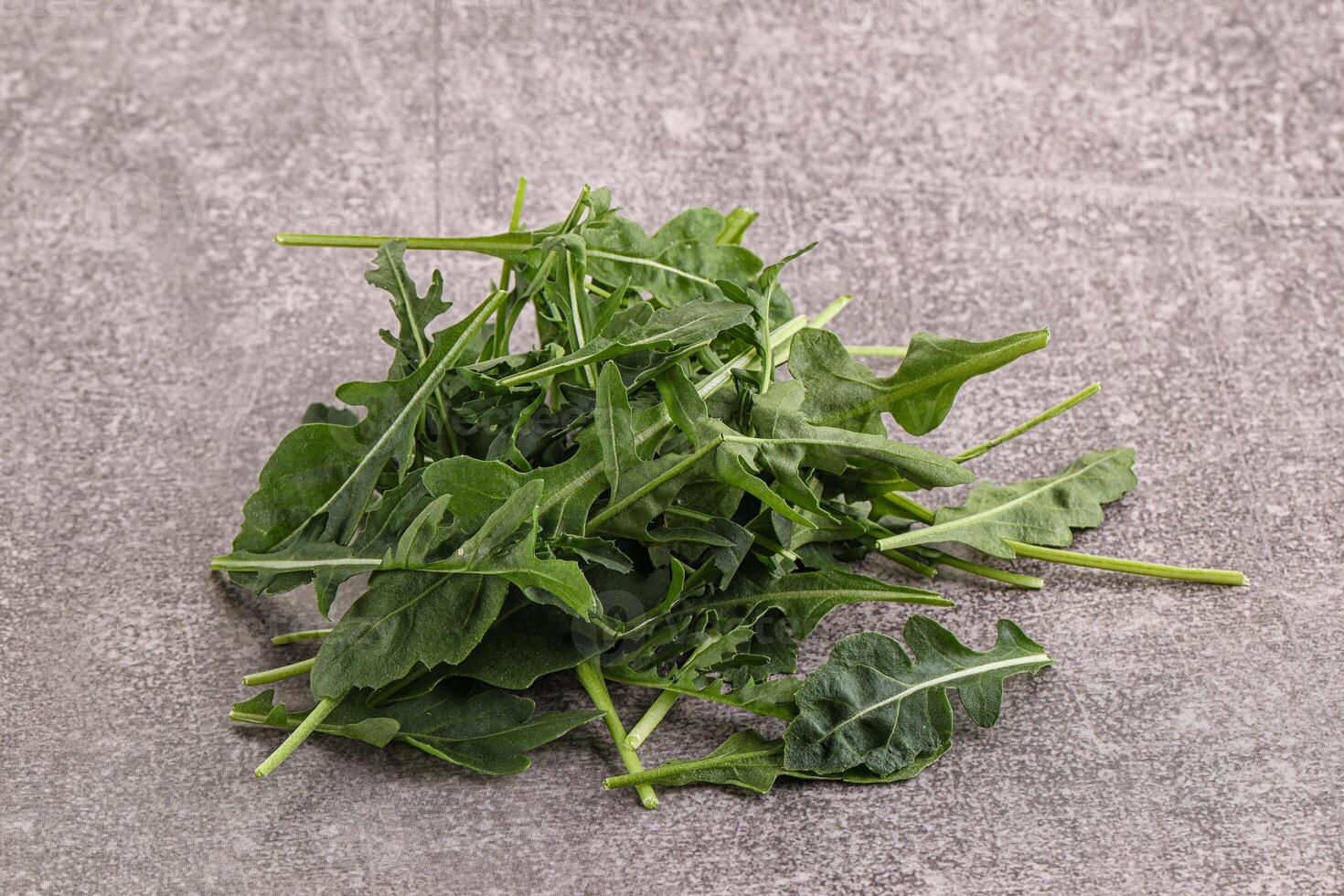 Green Arugula heap over background photo