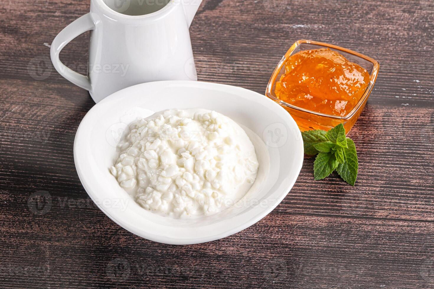 Grain curd with cream and jam photo