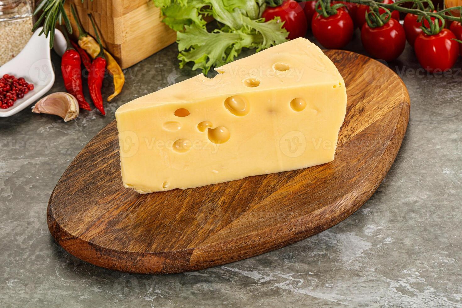 Swiss Maasdam cheese triangle over board photo