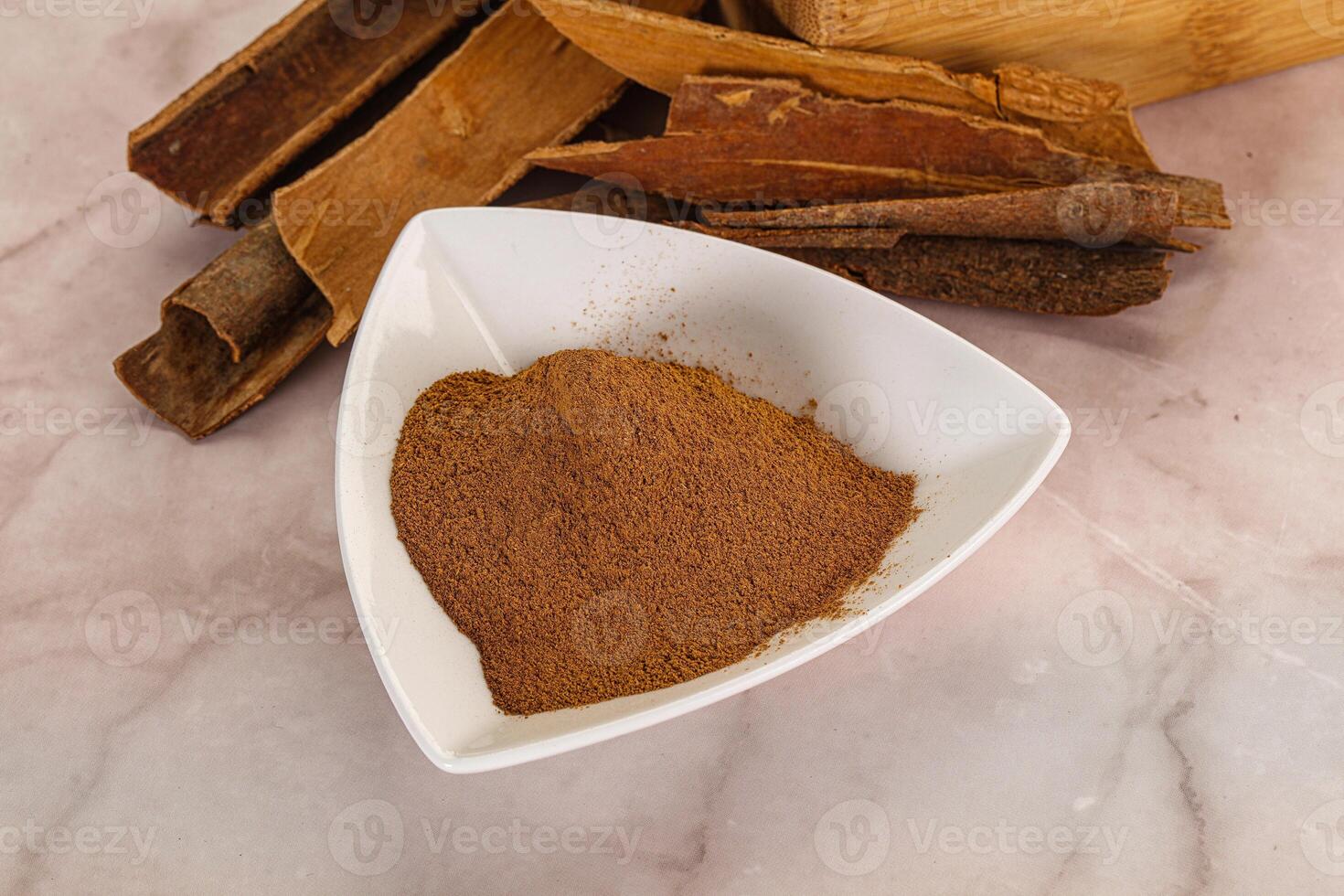 Natural Cinnamon powder with sticks photo