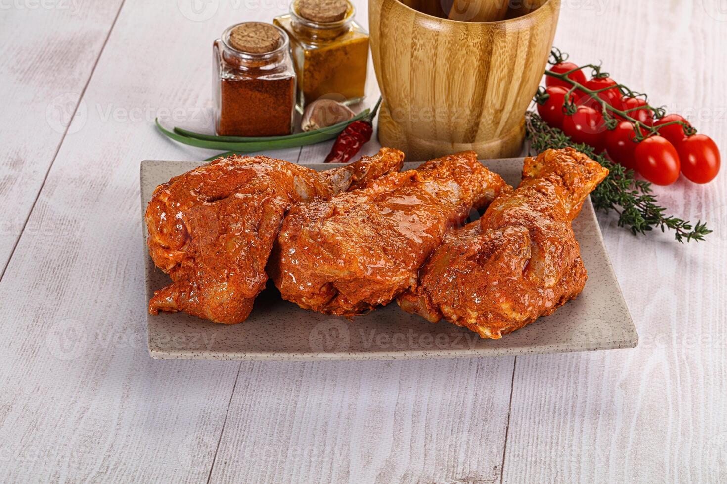 Raw turkey shoulder wing in Indian tandoori marinade photo