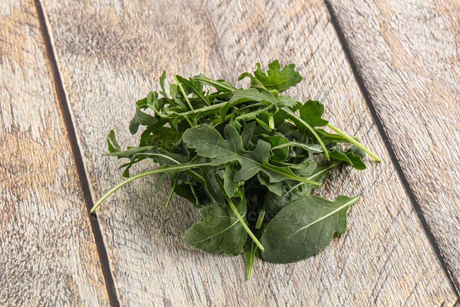 Green Arugula heap over background photo