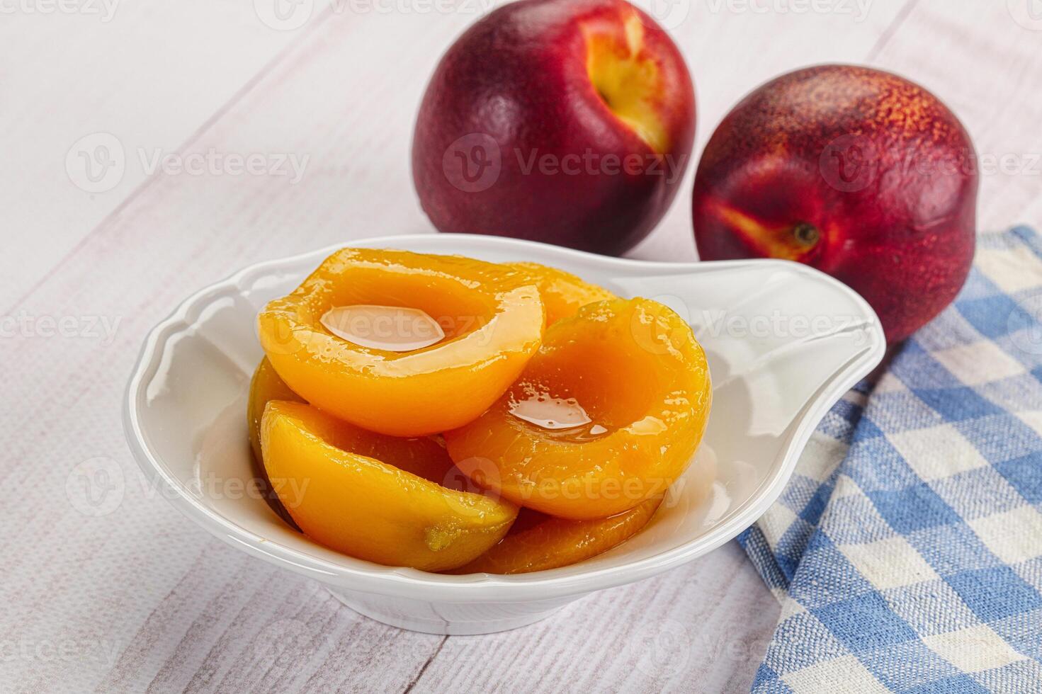 Canned peaches with sweet syrope photo