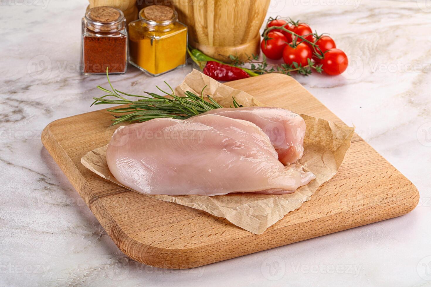 Raw chicken breast served rosemary photo
