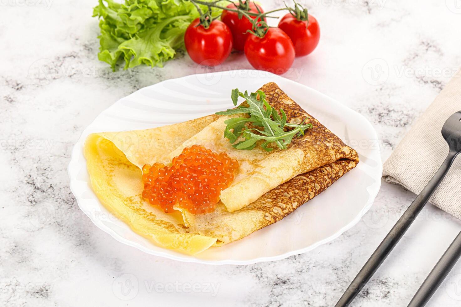 Russian pancake with red caviar photo