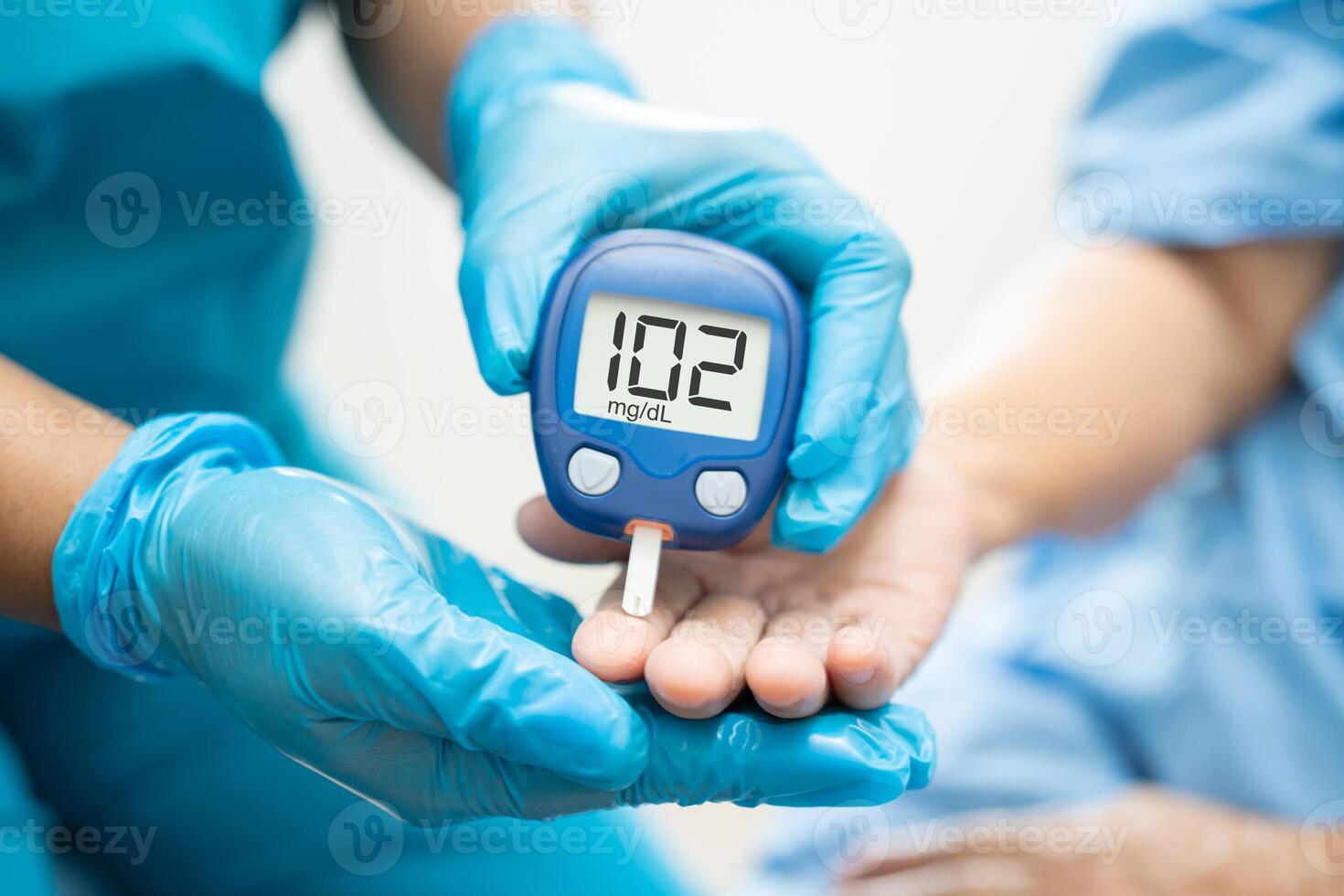 Doctor check diabetes from finger blood sugar level with finger lancet. photo