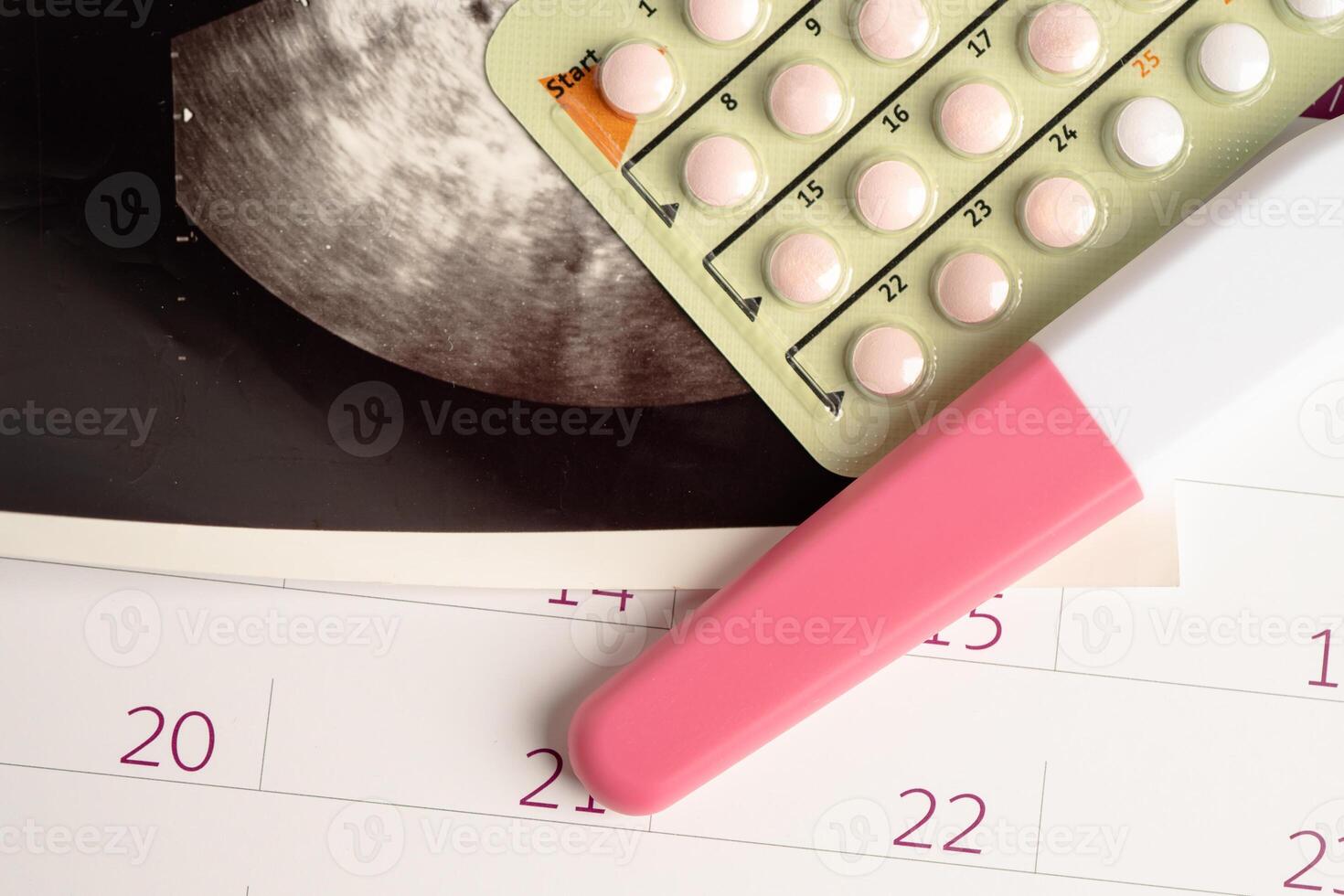 Pregnancy test and birth control pills with ultrasound scan of baby uterus, contraception health and medicine. photo