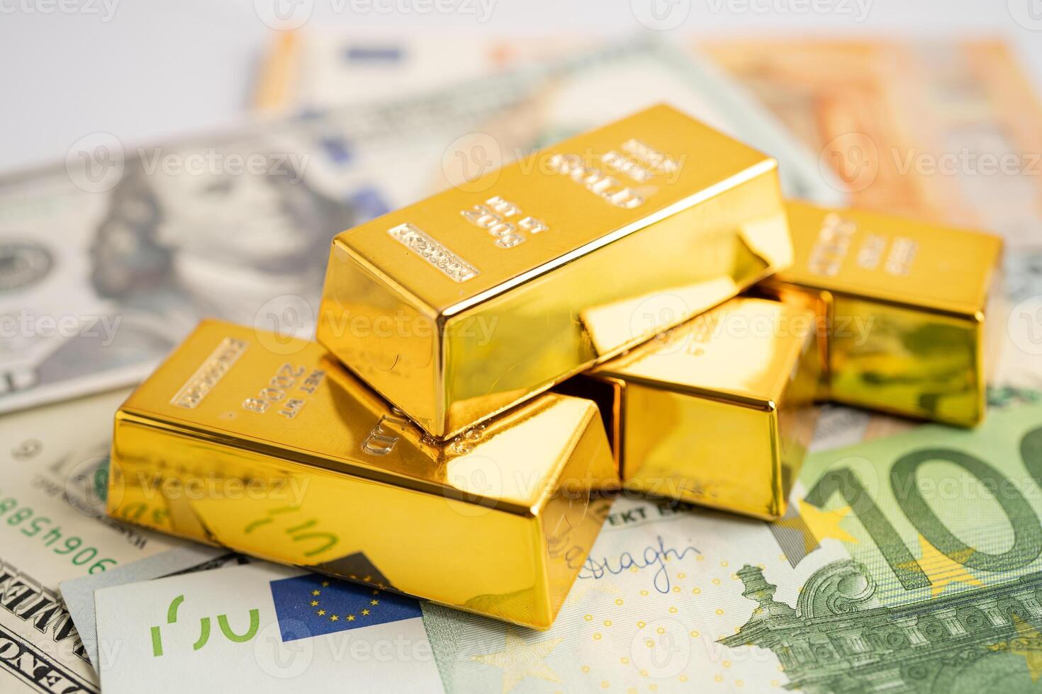 Gold bar on US dollar and Euro banknote, economy finance exchange trade investment. photo