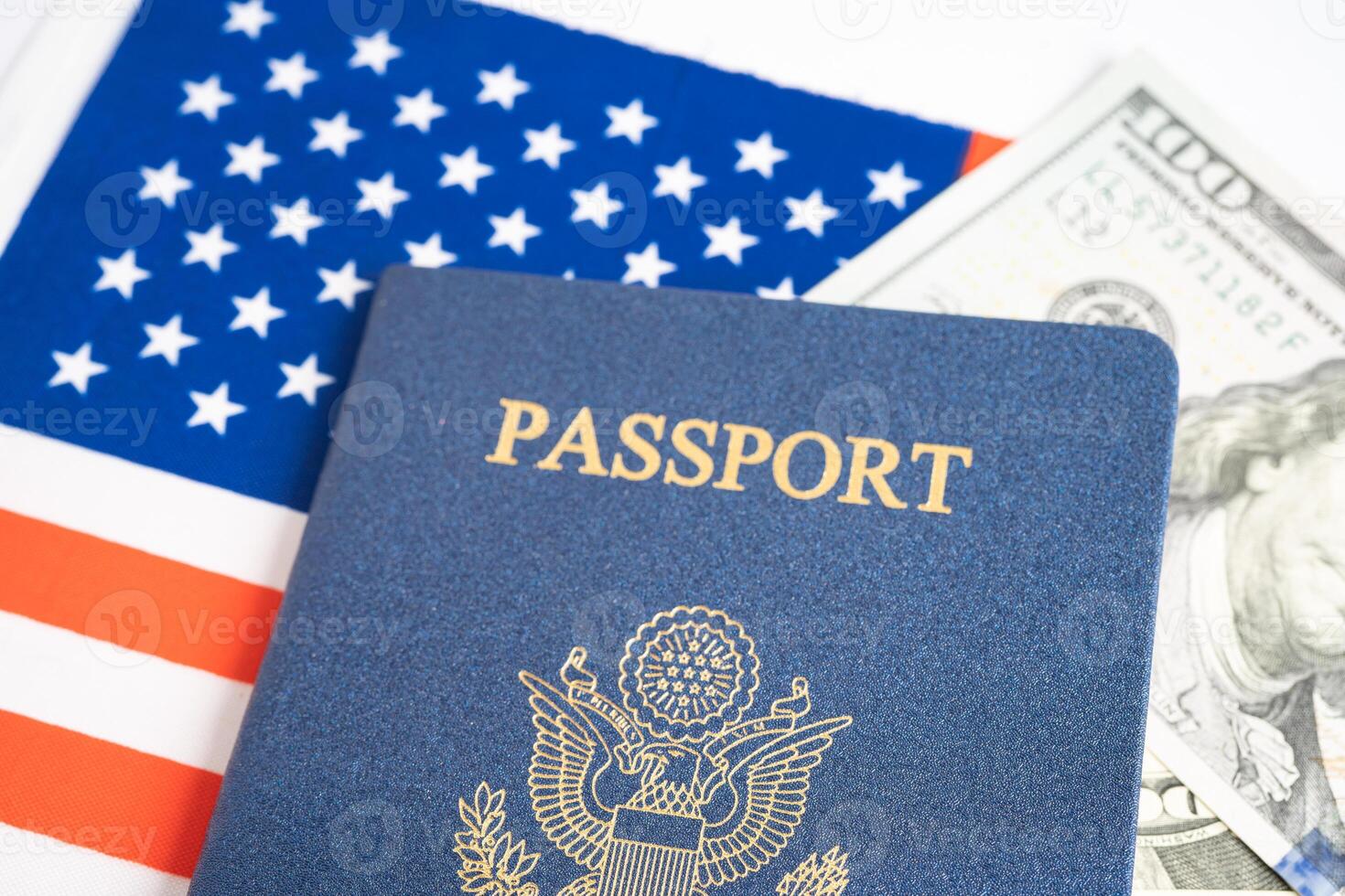 US passport issued to citizen and national of the United States of America to travel in most countries outside with USA flag and dollar money. photo