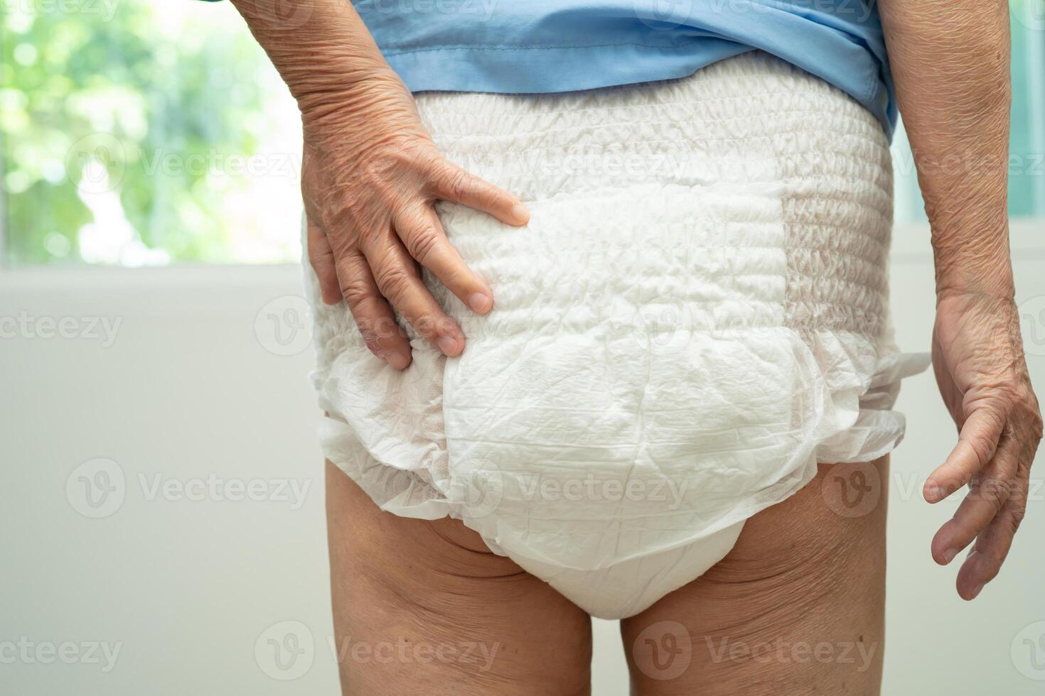 Asian senior woman patient wearing incontinence diaper in hospital, healthy strong medical. photo